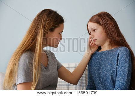 Family problems concept. Mother becalming girl