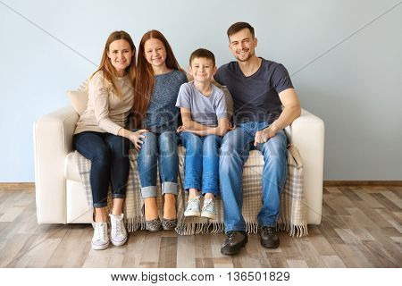 Happy family sitting on sofa