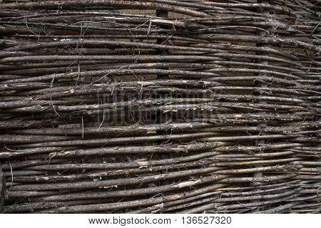 stale old wicker fence made of willow twigs