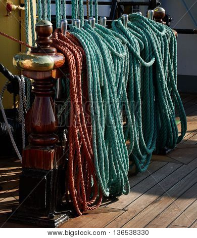 Rigging of a sailing ship, green and red ropes, blocks