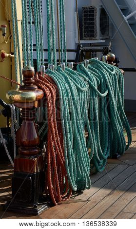 Rigging of a sailing ship, green and red ropes, blocks