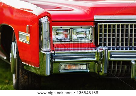 MINSK BELARUS - MAY 07 2016: Close-up photo of the red Cadillac Eldorado 1976 model year. Headlights of vintage car.