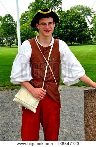Lexington Massachusetts - July 10 2013: Guide dressed in 1775 clothing standing on the Village Green where the first shots of the American Revolution were fired on 11 April 1775