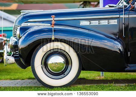 MINSK BELARUS - MAY 07 2016: Close-up photo of black Buick Eight 1940 model year. Vintage retro auto. Fender and the front wheel of the car. Side view. Selective focus.