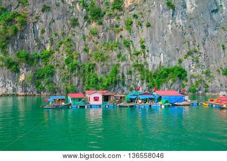 Floating fishing village and rock islands in Halong Bay Vietnam Southeast Asia. UNESCO World Heritage Site.