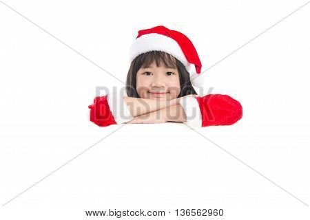 Little asian girl in in Santa Claus uniform with an empty banner isolated on white