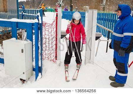 MOSCOW REGION, RUSSIA - DEC 28, 2014: Girl (with model release) equipped for skiing at turnstile at Sports complex Stepanovo. Sports complex Stepanovo is located 50 km from Moscow.