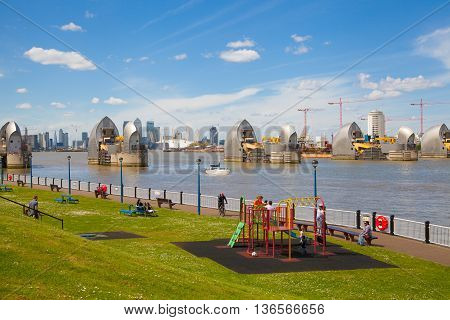 London, UK - May 4, 2015: London barrier on the River Thames view and park with children's playground