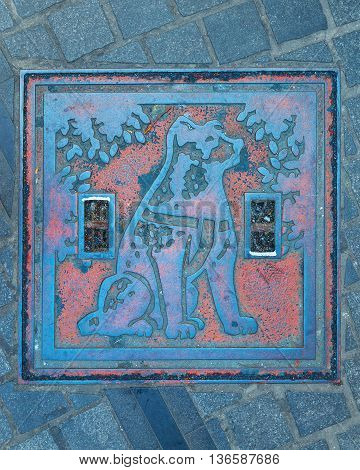 TOKYO JAPAN - NOVEMBER 28 2015: Hachiko manhole cover at Shibuya station the dog is remarkable loyalty to his owner which continued for ten years waiting for his owner at thw station after his owner's death