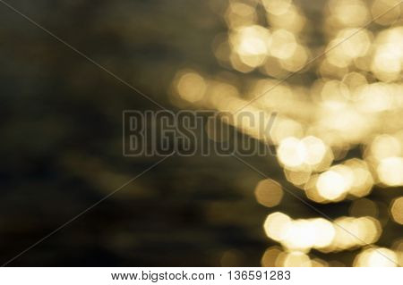 The sun's rays on the water surface in defocus