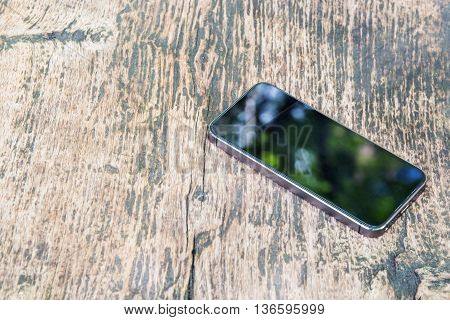 Moblie smart phone on wood table background