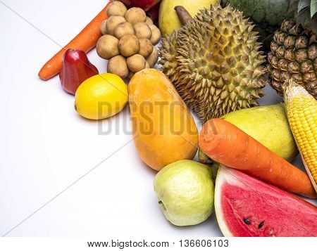 Mix colorful asian fruits of lemon watermelon pineapple papaya durian guava mango corn rose apple carrot and southern langsat on isolated / white background