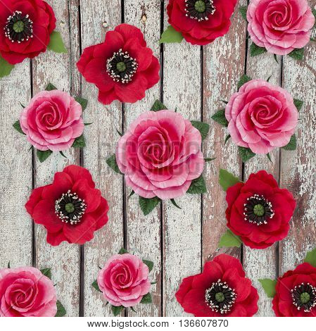 Abstract background of flowers.Handmade flower fabric foamiran. Poppies and roses on vintage wooden background.