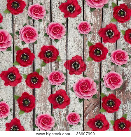 Abstract background of flowers.Handmade flower fabric foamiran. Beautiful flowers made of sponge rubber. Poppies and roses on vintage wooden background