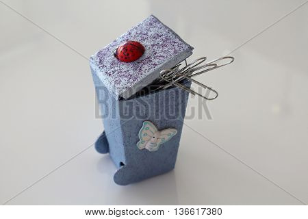A small hand-made waste bins decoupaged with ladybug and butterfly handmade objects decorated using different techniques of decoupage
