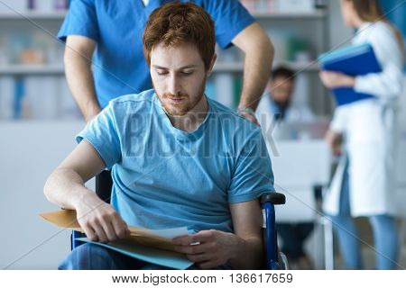 Healthcare Worker Pushing A Man In Wheelchair