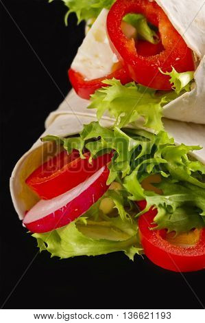 Vegan shawarma wrap roll with vegetabes and cheese.