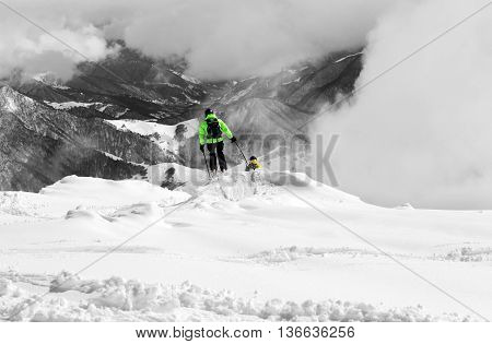 Freeriders on off-piste and mountains in mist. Caucasus Mountains Georgia region Gudauri. Selective color.