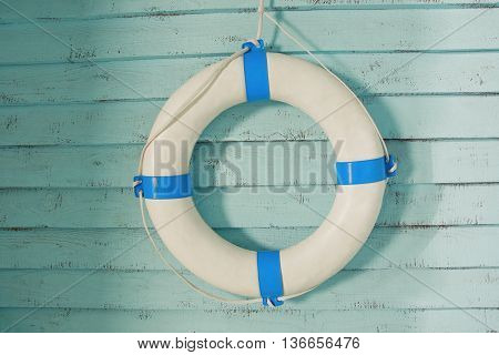 Retro lifebuoy on old wooden walll background