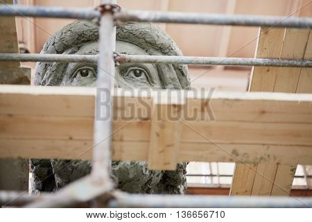 RUSSIA, MOSCOW - MAY 28, 2015: Scaffolding and fragment of head of clay sculpture to St. Prince Vladimir during manufacture in the workshop of sculptor Salavat Shcherbakov.