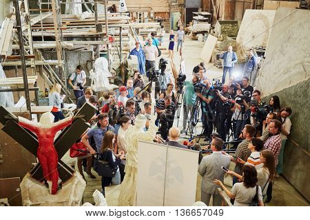 RUSSIA, MOSCOW - MAY 28, 2015: Press representatives take interview near clay sculpture to St. Prince Vladimir during manufacture in the workshop of sculptor Salavat Shcherbakov.