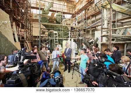 RUSSIA, MOSCOW - MAY 28, 2015: Press representatives take interview near clay sculpture to St. Prince Vladimir during manufacture in the workshop of sculptor Salavat Shcherbakov.