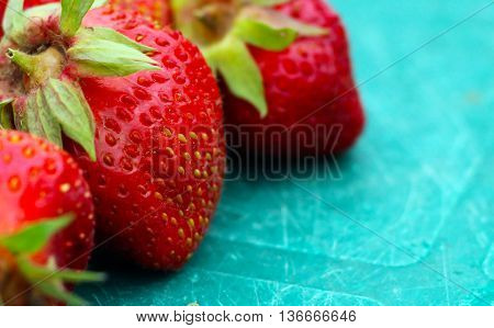 Fresh strawberries on blue table. Sweet berry.