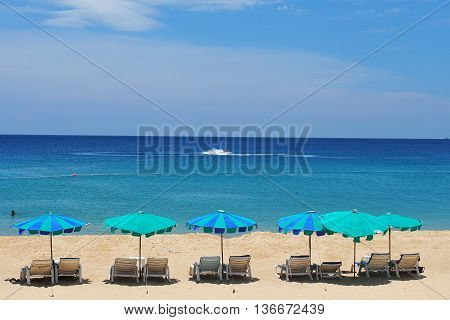 White Sand Beach With Chairs And Blue Sky