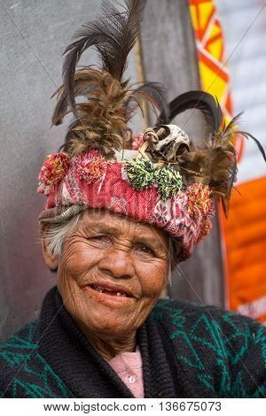BANAUE PHILIPPINES - JANUARY 24 2014 : Unknown old ifugao woman in national dress next to rice terraces. Ifugao - the people in the Philippines. Refers to the mountain peoples.