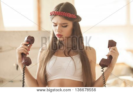 pretty woman talking on old telephone. Fashion model. Red lips. Sunny color.