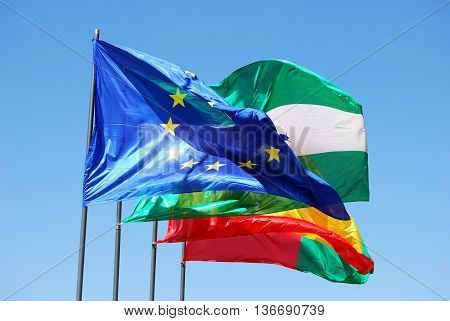 Four flags in a row comprising of Spanish Andalucian European Union and Granada at thPalace of Alhambra)