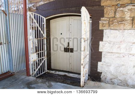 FREMANTLE,WA,AUSTRALIA-JUNE 13,2016: Old doors with security gate at the Fremantle Prison in Fremantle, Western Australia.