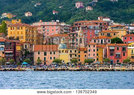 SAN TERENZO LERICI ITALY - JULY 28 2014: San Terenzo (St. Terenzo) beach crowded with bathers in a July evening. Lerici in the Gulf of La Spezia Liguria Italy