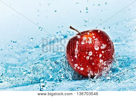 image of fresh water splash on red apple