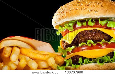 Tasty Hamburger And French Fries On A Dark