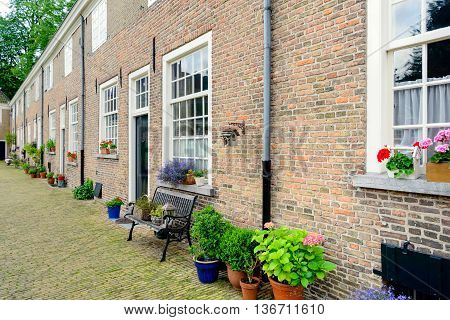 Row of historic houses with masonry brick facades in the Begijnhof in the Dutch city of Breda. This beguinage is the oldest beguinage in the Netherlands.