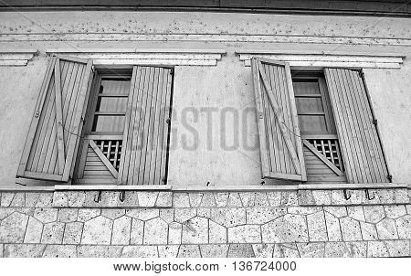 Great big window with huge wood shutters in black and white