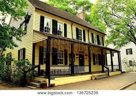 Old Salem North Carolina - April 21 2016: Old Salem Tavern still serves colonial restaurant food with wait staff dressed in 18th century Moravian clothing