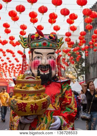 BANGKOK THAILAND - FEBRUARY 09 2016 : Thai man in traditional masks and costumes the street of Yaowarat in Chinatown during the celebration of Chinese New Year and Valentine's Day.
