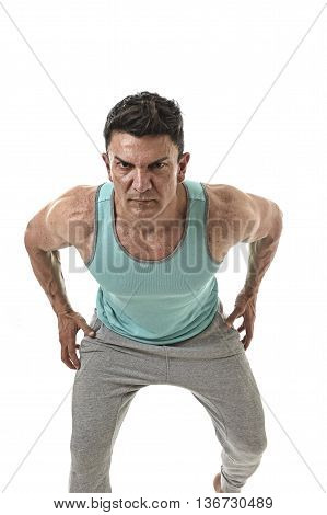 40s attractive hispanic sport man and bodybuilder in attitude corporate pose with strong shoulders wearing singlet having very fit and muscular body in mature bodybuilding and body care isolated