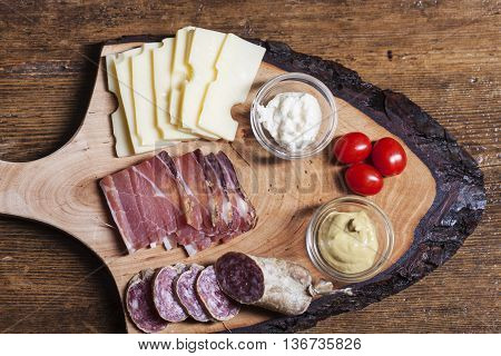south tyrolean specialites with tomato on wood
