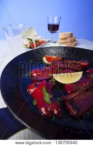 greek florini peppers in a pan with wine