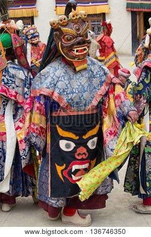 LAMAYURU INDIA - JUNE 13 2015: Unidentified buddhist lamas dressed in mystical mask dancing Tsam mystery dance in time of Yuru Kabgyat Buddhist festival at Lamayuru Gompa Ladakh North India
