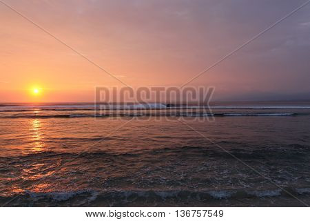 The sunsets across the waves in South Sumatra. This remote area is home to beautiful coastline and surf breaks such as this one south of Krui.