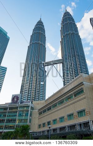 KUALA LUMPUR MALAYSIA - FEBRUARY 29: Petronas Twin Towers during evening on February 29 2016 in Kuala Lumpur Malaysia. Petronas Twin Towers with Suria KLCC Mall.