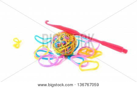 Pile of multiple colorful rubber toy loom bands isolated over the white background