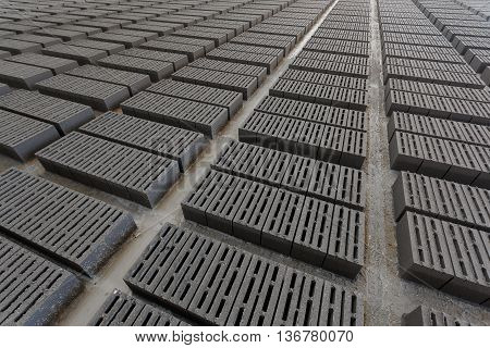 Stack of bricks. Manufacturing of aerated concrete blocks. Manufacturing of cinder block. The plant manufactures building material. The plant produces a cinder block. Cinder block-building material.