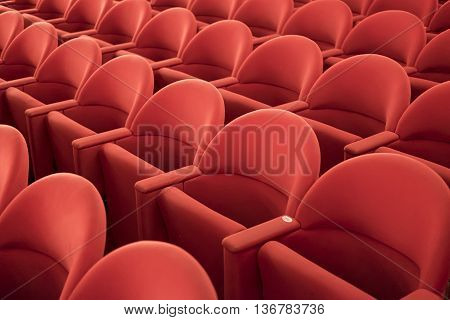 Typical theater empty red seats in row.