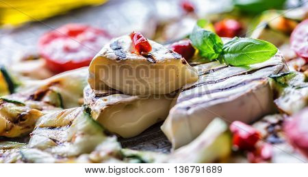 Grill Brie camembert cheese zucchini with chili pepper and olive oil. Italian mediterranean or greek cuisine. Vegan vegetarian food.