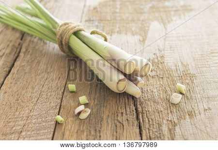Bundle of lemon grass and sliced on wood table.